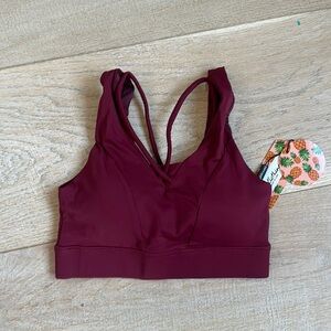 NEW WITH TAGS athletic top with cute criss cross detail, bra cups, lined XS.